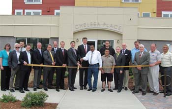 Manager Jay Ash joined representatives from Federal Realty Investment and local officials and business leaders for the ribbon-cutting ceremony for Chelsea Place, a fourstory, 56-unit apartment complex located in Chelsea Commons. Councilor-at-Large Leo Robinson had the honor of assisting with the actual cutting of the ribbon.