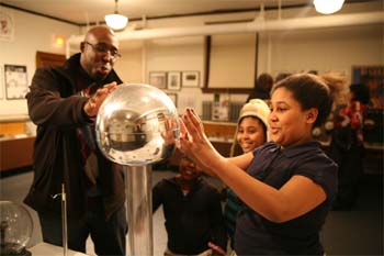 Desayna Christmas gets her hands as close as she can stand to the electrostatic globe at the new Lewis Latimer Museum, which was unveiled Tuesday night along with a presentation in City Hall for the 150th Civil War Anniversary. She was joined by (right to left) Dhalia Christmas, Chawanzi Mowena and Dakeya Christmas.