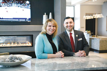 The new TownPlace Suites on Eastern Avenue opened up March 6, but this week already saw two sellout nights at the new 140-room hotel. Here, Julie Scott, senior VP of sales and revenue management, and Joe Fiorello, sales manager, show off the impressive lounge at the new hotel.